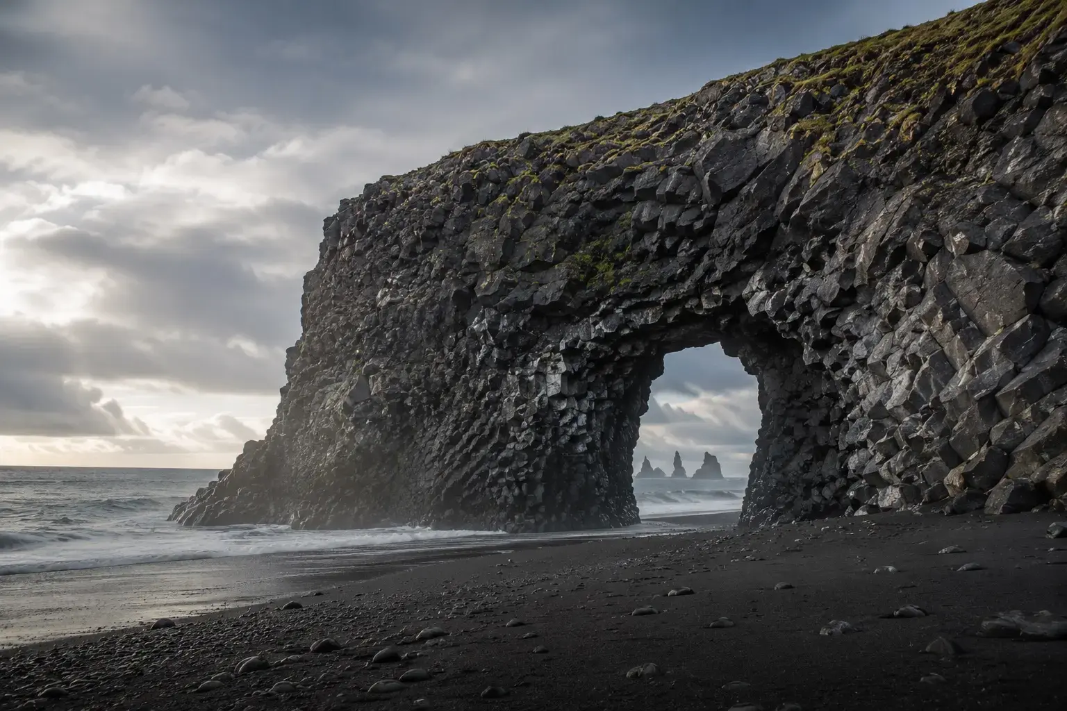 Adventure Quest artwork from the Fjords of Iceland Cruise collection: a basalt sea arch on a black-sand beach.