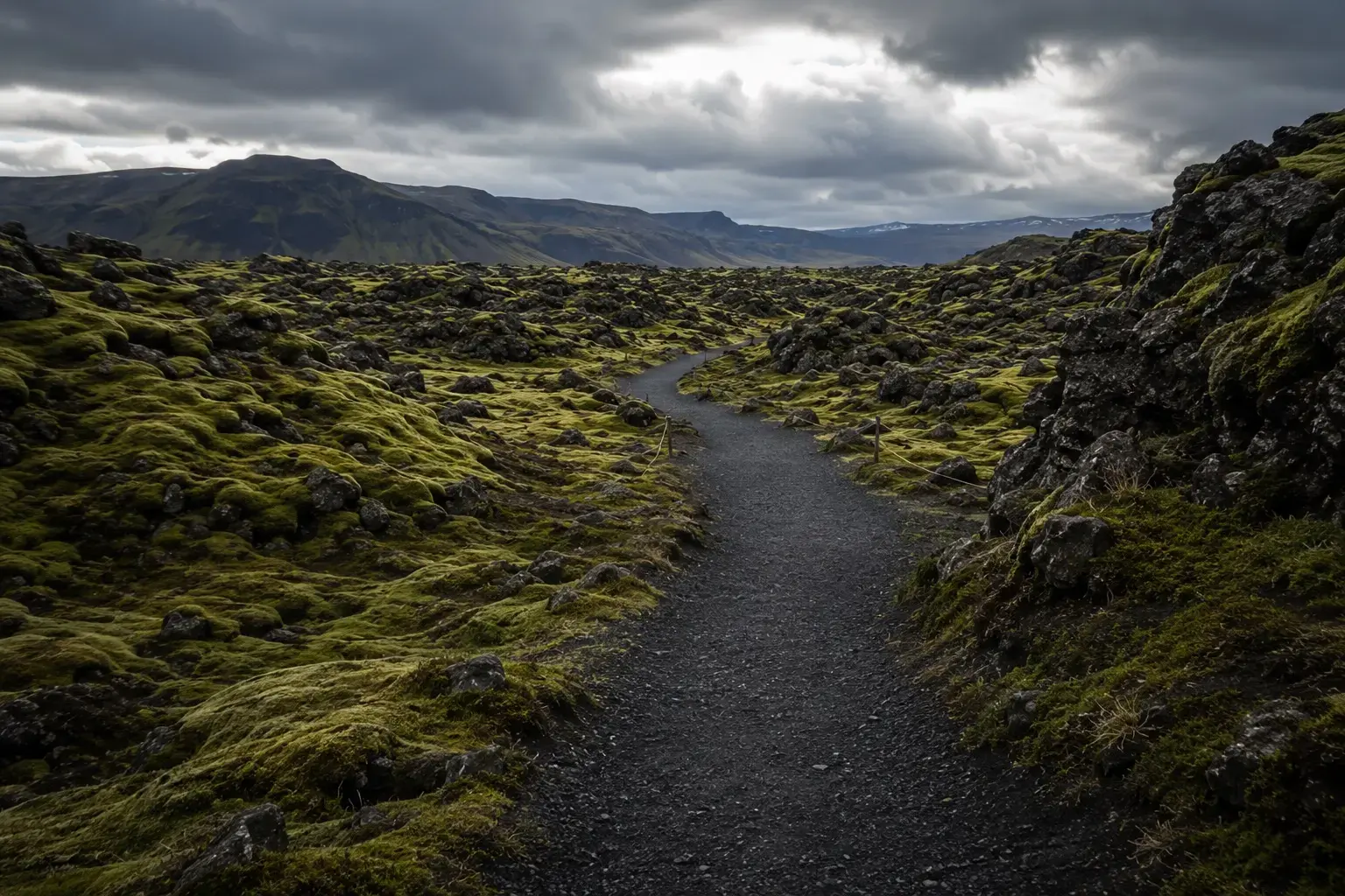 Adventure Quest artwork for the Lava & Moss Explorer adventure: a gravel path winding through a moss-covered lava field under grey skies.